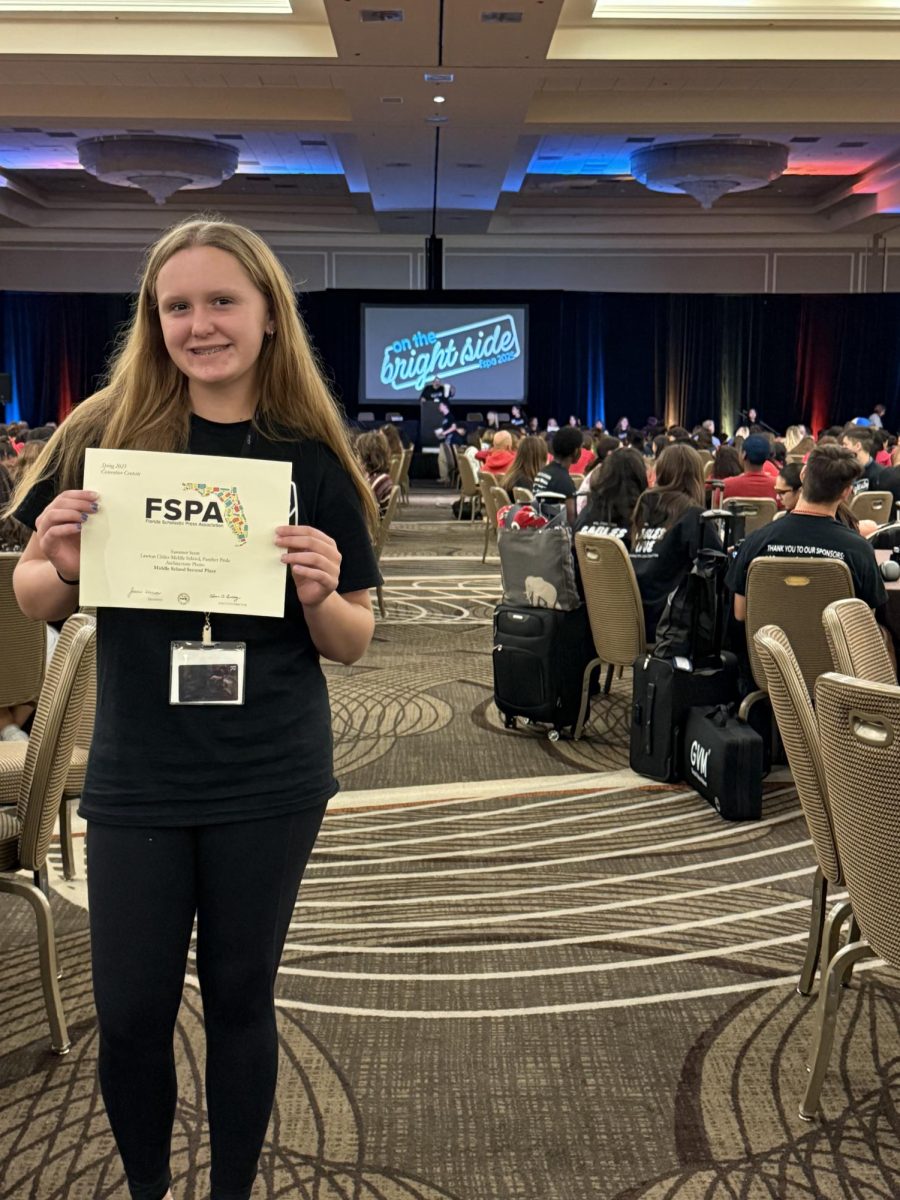 Summer Scott is showing off her second place award for winning an architecture photo contest. “It was fun to take pictures and hang out with my friend,” Summer said.