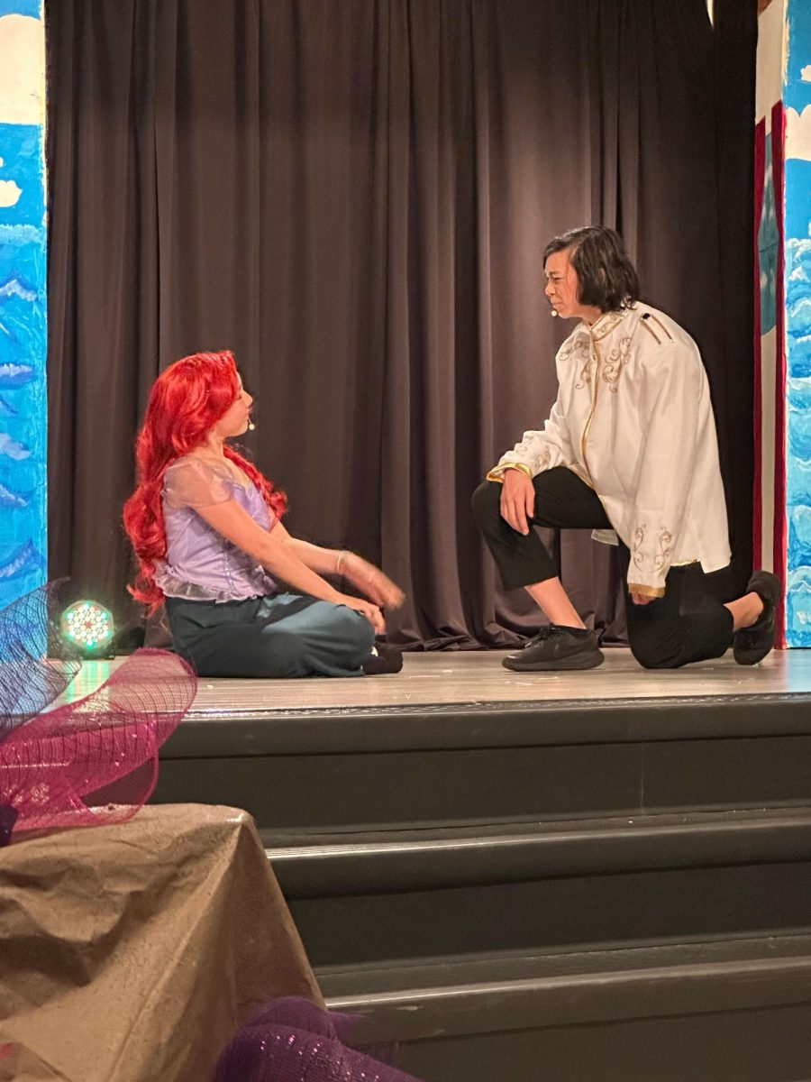 Prince Eric (Evan Lam) finds Ariel (Elina Garcia) washed up on the shore.