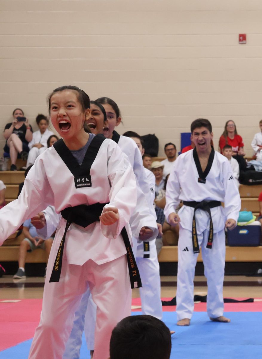 World Class!!!!
Maggie Li (7th) leads the ending formation in the black belt demonstration. The demonstration happened in the Lawton Chiles gym. Maggie said, "I was screaming because the music was loud".
