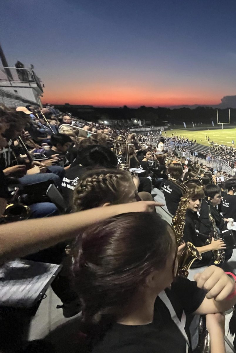 
As the sun sets on the Hagerty High School football field, the middle schoolers watch with their high school partners.