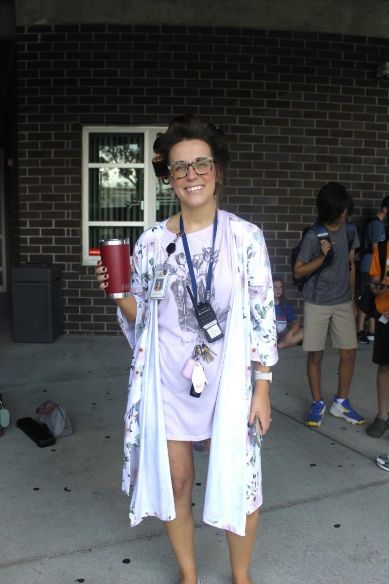 Mrs. McDonald dressed in a robe and hair rollers to celebrate Tired Teacher Thursday.
