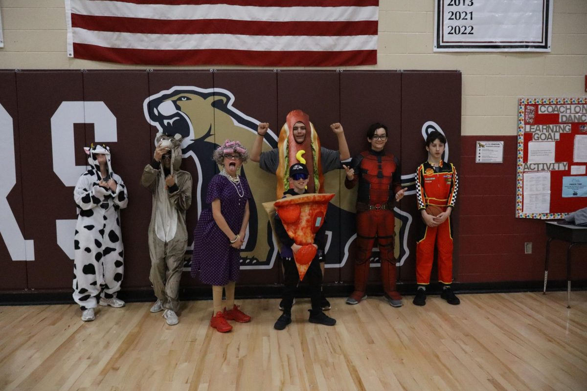 PE students dress up in their costumes for red ribbon week.