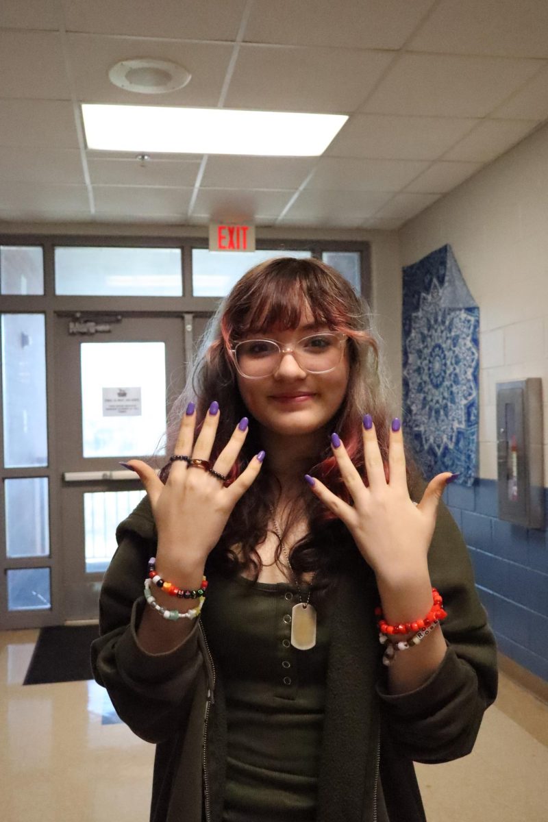 Alana Fonseca Diaz with her rings and bracelets she made. 