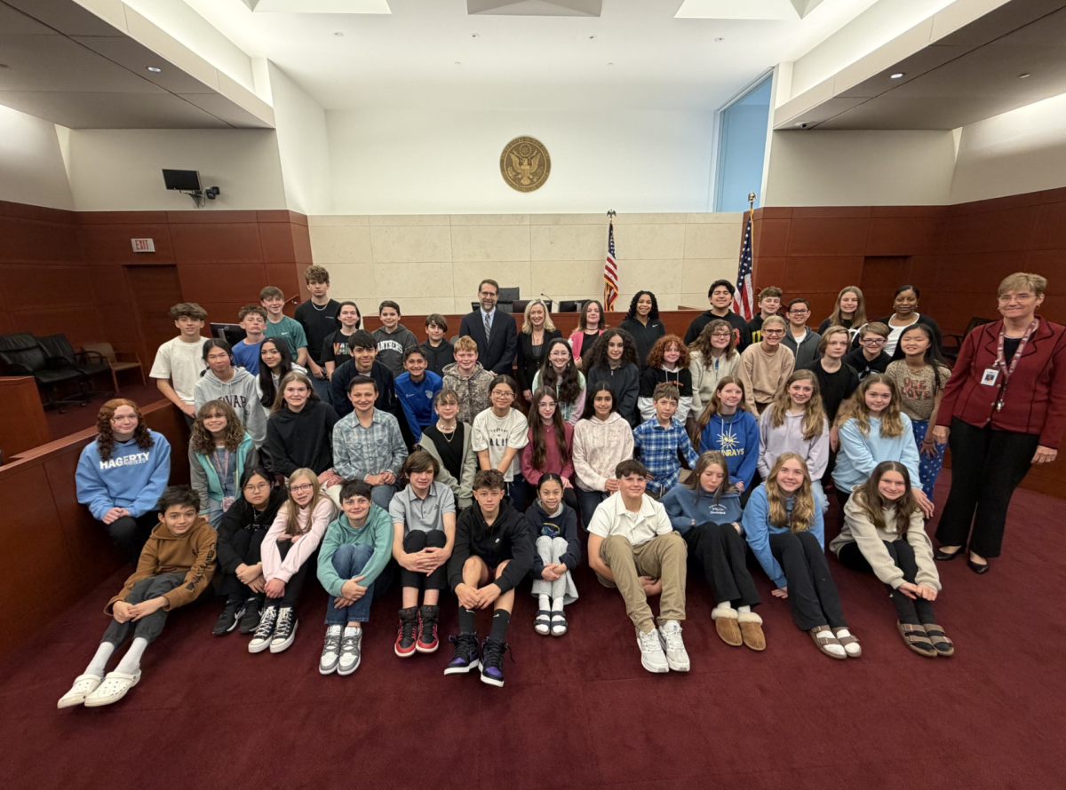 During the field trip to the courthouse, students were able to take a photo with two judges.