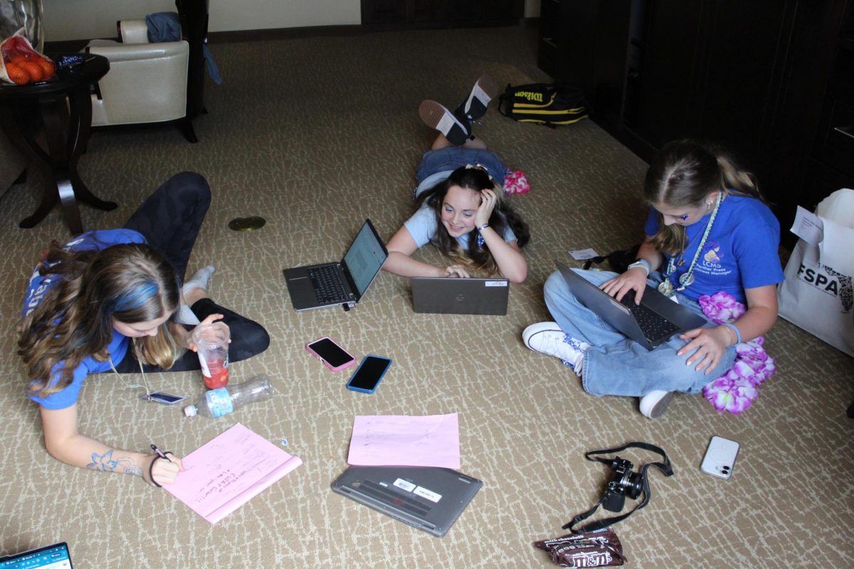 Abby Frail, Zoey Greenstein, and MJ Schwabe work on their "on the spot" spread.