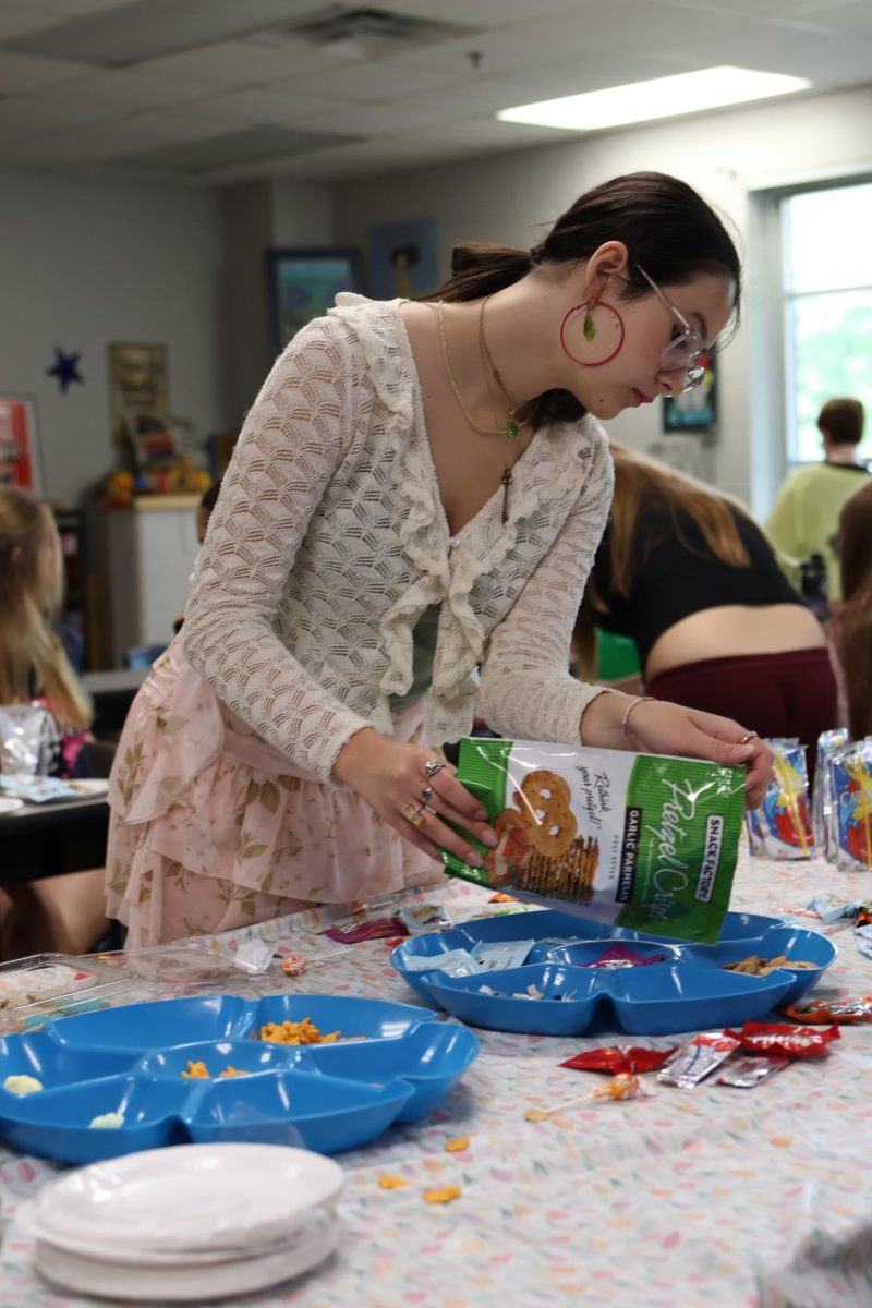 Sophia Thomas is organizing and preparing snacks for the easter event.