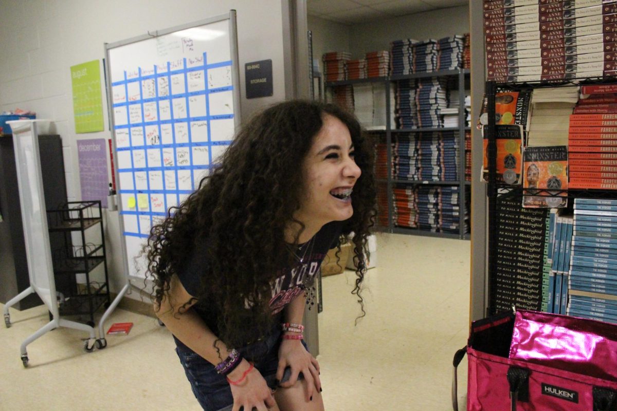 Mila Kiray laughs with friends, during the end of the year yearbook party.