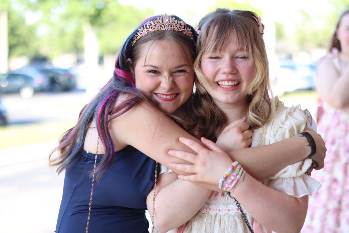 Delia Irvine-Campbell and Payten Robillard hug each other before the 8th grade dance.
