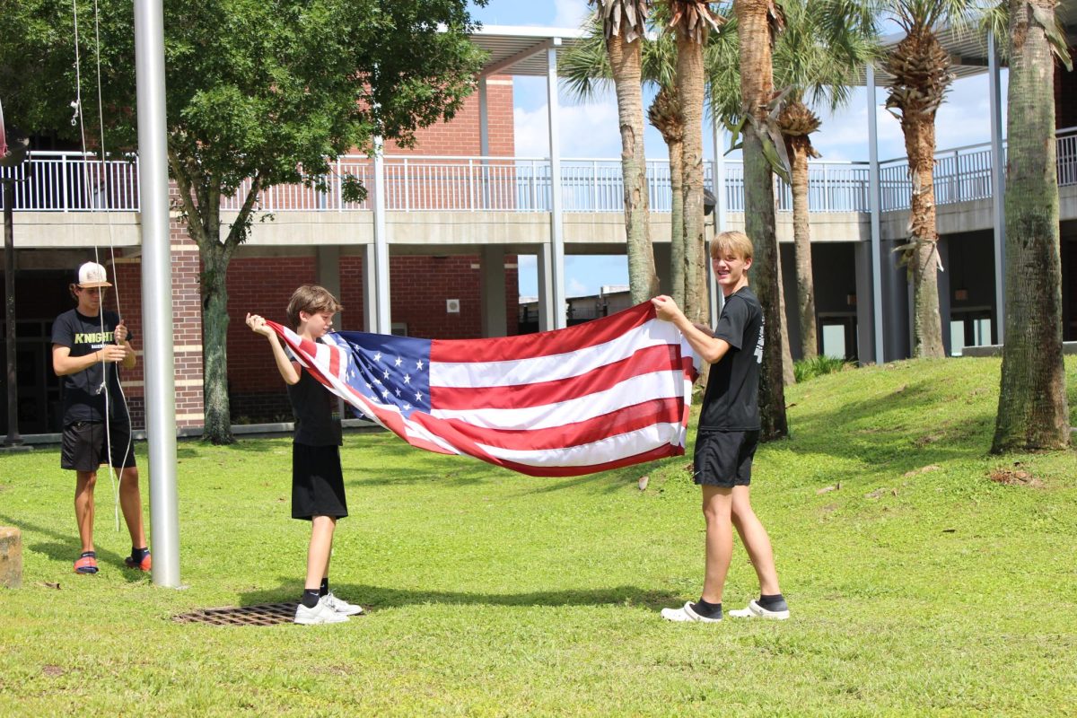 Truett Bock and Easton Hubbard fold the flag.