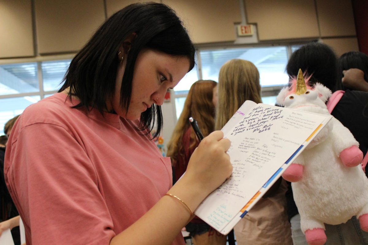 Skylar Ross(8) is signing all her friends yearbooks before she goes to highschool.