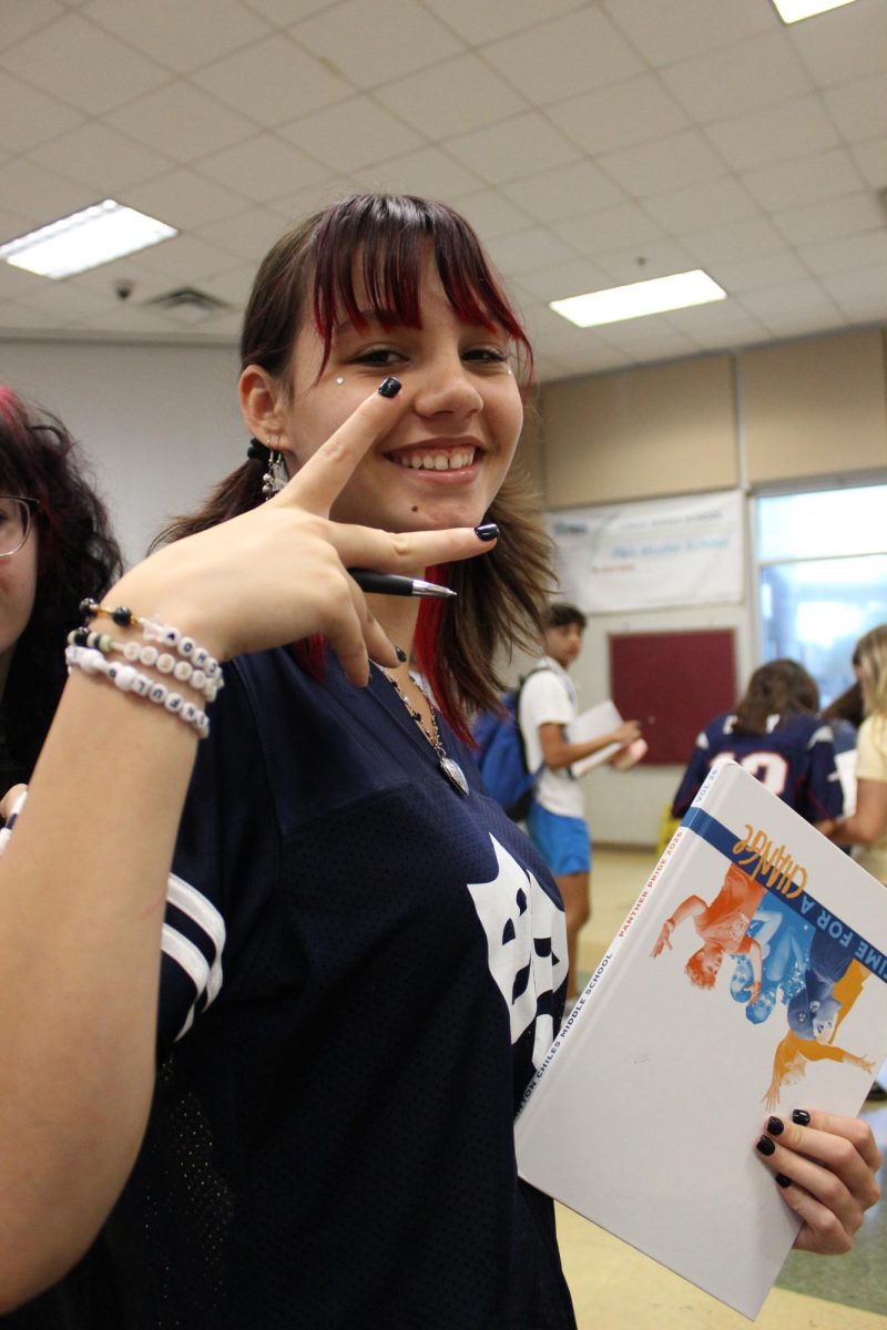 Ana Grigoletti Domit is hanging out and signing her friends book during the last classes of the day. The 8th grade yearbook signing party consisted of popcorn, soda and hyped up panthers trying to get their friends signatures before they head off to highschool.