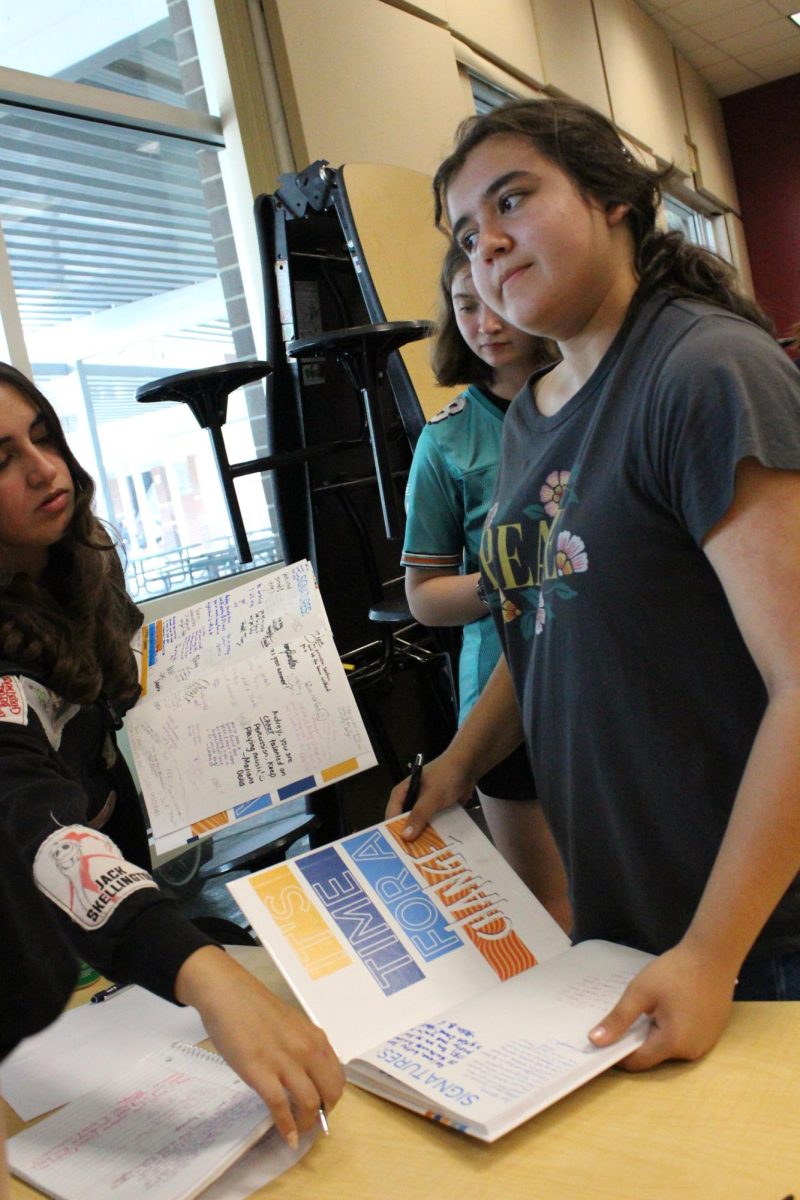 Adrianna Campos (8) is making sure to get all her friends signatures.
